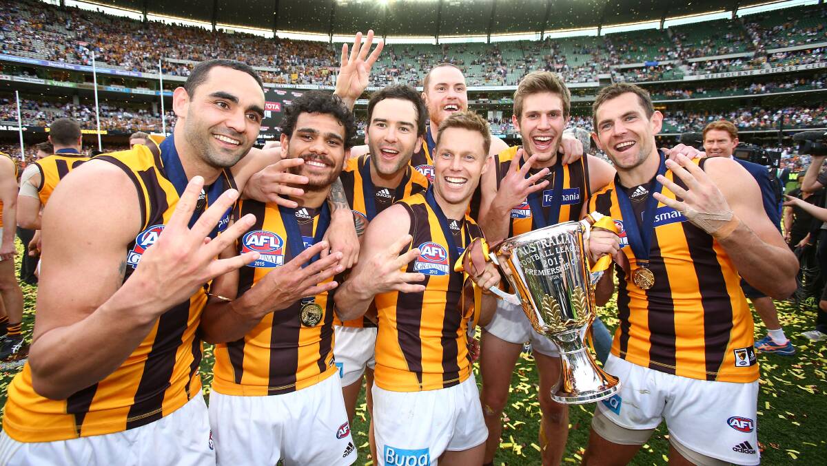BIG DAY OUT: Hawthorn players celebrate their win. The grand final is the pinnacle of a sport that mirrors so much of the Australian way of life.