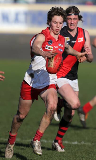 BEST: South Warrnambool's Jock Blair kicks the ball forward after a blistering run from defence. Blair was the Roosters best in their win over Cobden. Picture: Rob Gunstone