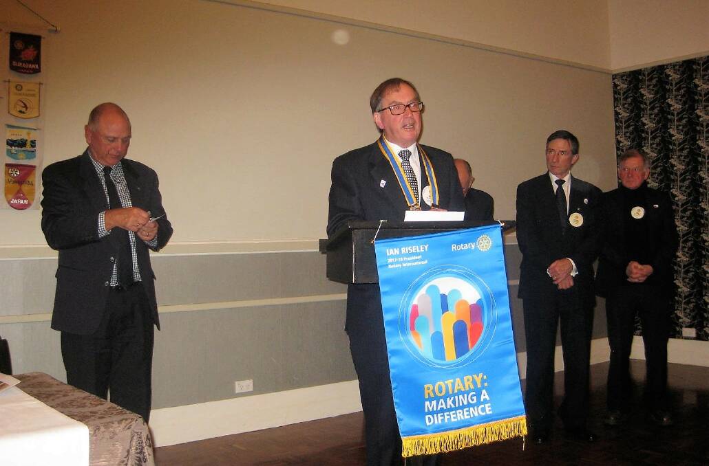 IN CHARGE: Port Fairy Rotary Club members listen as new president Bill Moore makes his acceptance speech.