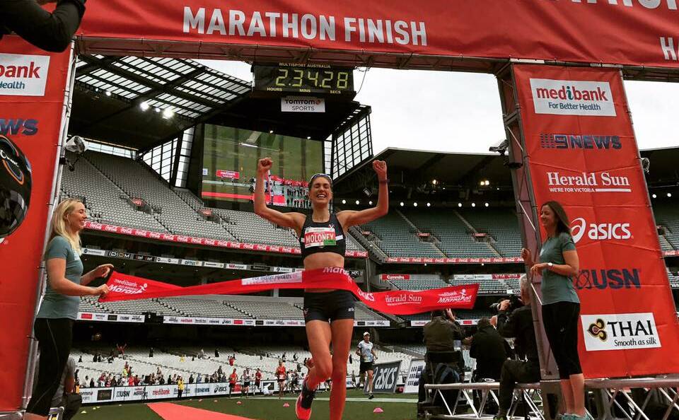 VICTORY: Virginia Moloney shows her elation as she crosses the finish line of the Melbourne Marathon at the MCG on Sunday. Moloney was the first female runner to complete the race.