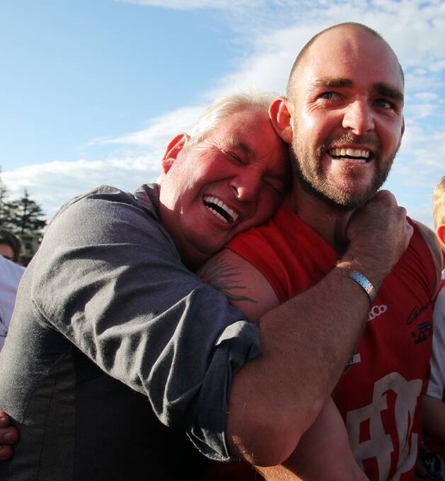 EMOTIONAL: This photo of Geoff and Darcy Lewis was in the grand final record.