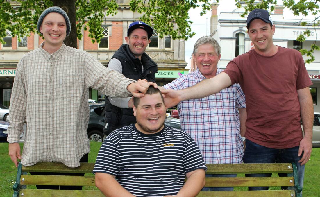 SACRIFICE: Aaron Carlin (seated) gets some love from Patrick Kenna, Damian Coolahan, Jack Kenna, from Let's Talk, and Tyler McColl ahead of Tuesday's World Mental Health Day. Picture: Anthony Brady