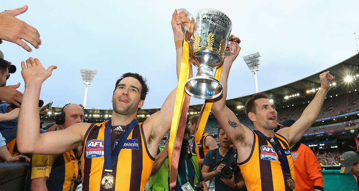 WINNERS: Former Warrnambool and Colac stars Jordan Lewis and Luke Hodge lift the 2015 AFL premiership cup. Hawthorn defeated West Coast Eagles by 46 points.  