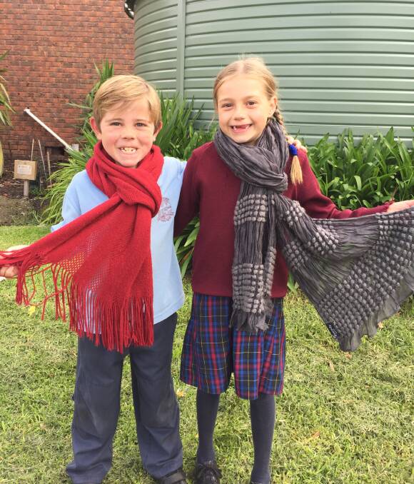 RUGGED UP: St Patrick's Primary School Port Fairy pupils Eamon West and Ivy Conlan, both 7, get their scarves out ready for the fundraiser on Tuesday. Picture: Madeleine McNeil 