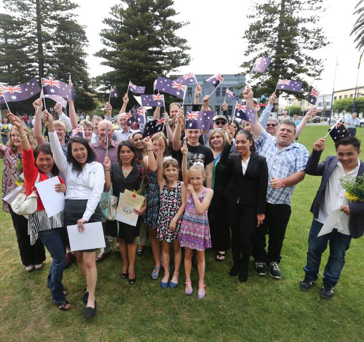PROUD: Some of the newest Australian citizens show off their new national colours on Warrnambool's Civic Green after taking the oath of allegiance on Wednesday. Picture: Amy Paton