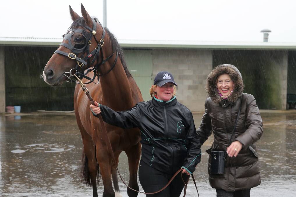 First lady of racing Gai Waterhouse, with jumper Valediction and strapper Sally Anne Bourke, braved bleak weather conditions during trials on Sunday. Picture: Rob Gunstone