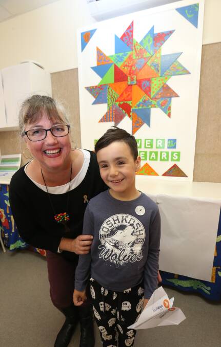 HAPPY BIRTHDAY: Artist and occupational therapist Rachel Peters and seven-year-old Jordan Grant with the mural celebrating Mpower's 40 years. Picture: Vicky Hughson