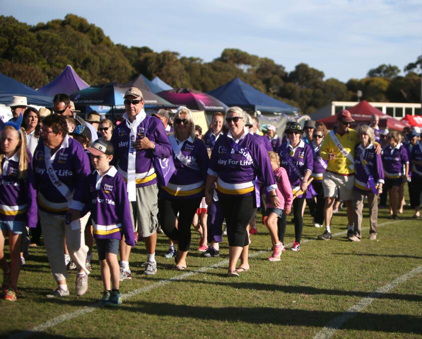 FIGHTING BACK: Survivors and carers take to the track for the initial lap of Warrnambool's Relay for Life. The annual event hopes to raise $90,000 for cancer research  this year. Picture: Amy Paton
