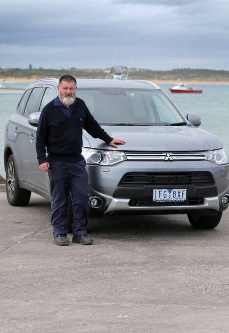 GOING GREEN: City council fleet team leader Terry Malone with the council's Hybrid Mitsubishi which has a range of 50 kilometres on a full charge. Picture: Rob Gunstone
