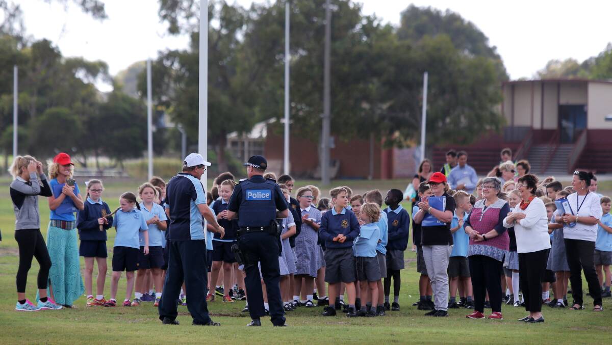 Police speak with students after St Joseph's Primary School was evacuated on Wednesday. Picture: Rob Gunstone 