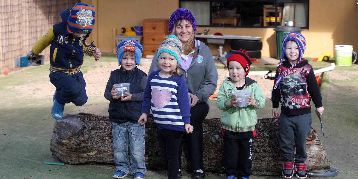 RAISING AWARENESS: Patrick Pearson, Charlie Williams, Grace Paslow, Harper Austin and Leo Pearson donned beanies to support Coarl Burleigh's brains cancer fundraiser on Friday. Picture: Damian White 