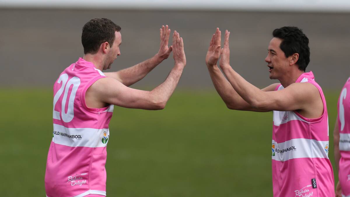 All Stars game players Michael Cooper and Stephen Chow high five during the match. Picture: Vicky Hughson