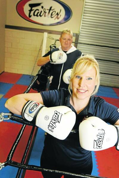 Boxing trainer Craig Parsons works with Australian rower Kathryn Ross ahead of the world championships in October.