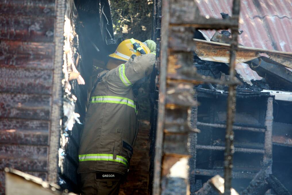 Flagstaff Hill Maritime village fire. A fireman looks over the damage.