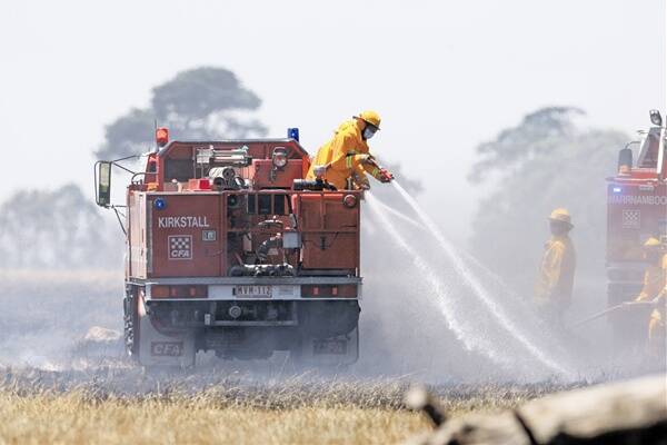 CFA members put out hot spots after a grassfire broke out yesterday along Koroit-Woolsthorpe Road, north of Koroit. 