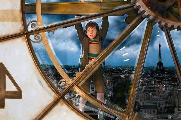 Hugo (Asa Butterfield) pays homage to Harold Lloyd's  Safety Last!  in the charming adventure  Hugo .