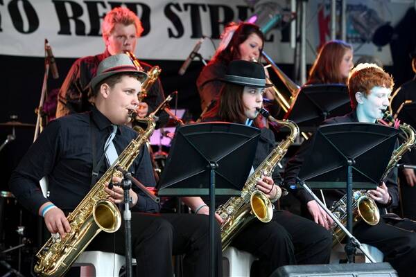 Ben Osmond, 16, Olivia Campbell, 15, and Nathan Booth, 15, play the tenor saxophone as part of the Mooroopna Secondary College Jazz Band in Reid St. Picture by Matthew Smithwick, BORDER MAIL.
