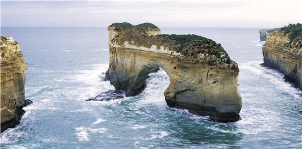 The Island Archway rock formation at Loch Ard Gorge before the collapse yesterday