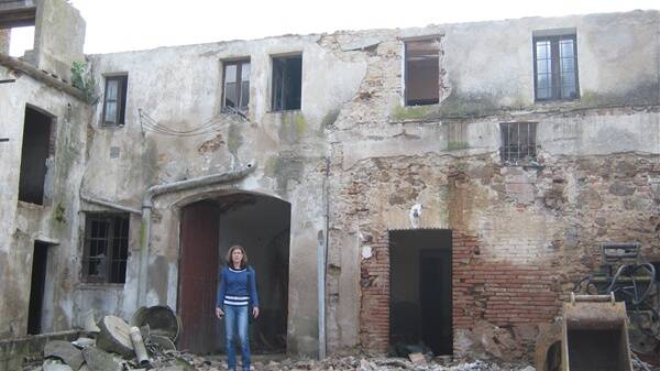 Jenny McLaren stands outside her ancestral home in Spain. She arrived the day it was being demolished.