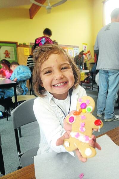 Nya Pionk, 3, makes a colourful gingerbread man.