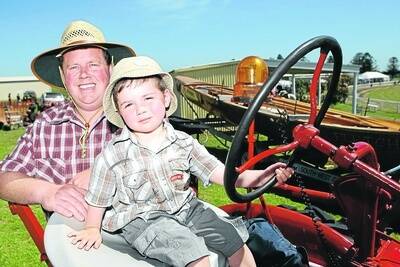 Riding high: Richard and Joseph Conlan, 3, from Port Fairy, try an old tractor for size. 091107AS20