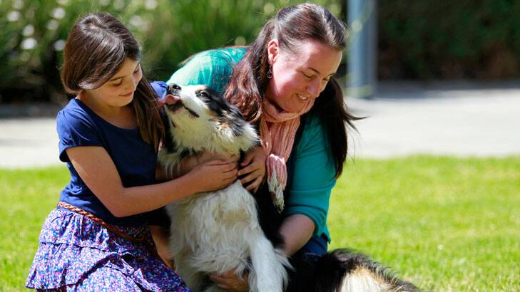 Jenny Stokes and her daughter Olivia, reunited with their dog Jet at the Lost Dog's Home in North Melbourne.