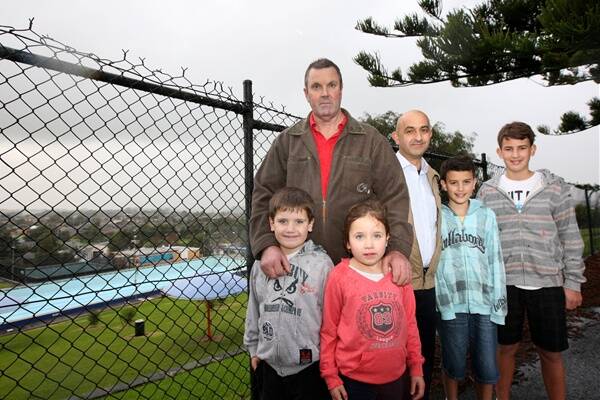 Chris Hynes (left), pictured with grandchildren Nicholas and Hannah Unwin, both five, and Peter Sycopoulis, pictured with sons Joe, 11, and Dominic, 13, want AquaZone’s diving pool restored. 