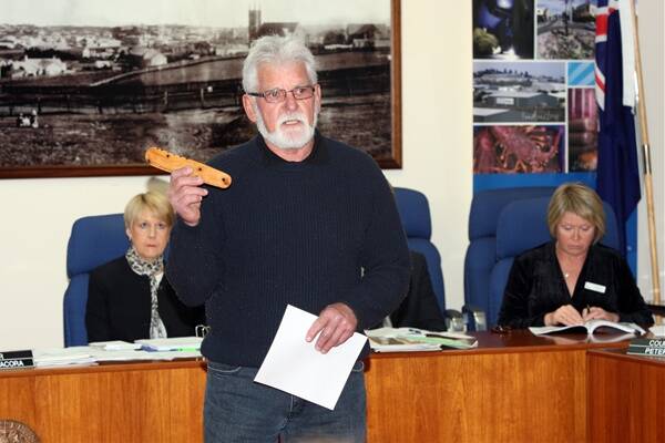 Robert Lowe delivers a symbolic message stick to Warrnambool City Council.