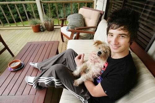 Macarthur's Liam Millard,18, takes a break with Cosmo at the family home after cheating death. 080716AM06 Picture: ANGELA MILNE