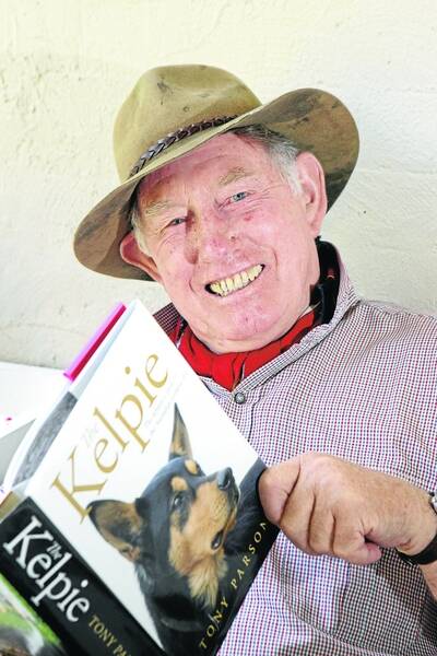 Retired kelpie breeder Tim Austin relaxes with a copy of the new book detailing the history of the breed. 101202AS06 Pictures: aaron sawall