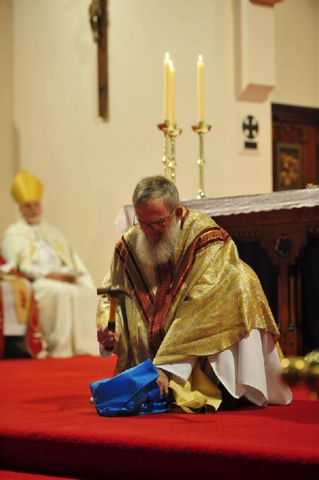 Bishop Hough smashes a chalice during his final service. PIC: The Age.