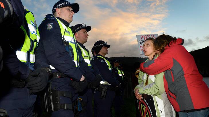 Protesters and police at the Tecoma McDonald's site, where a woman has been removed from the roof this morning. Photo: Penny Stephens