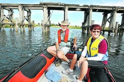 Nestles Rowing Club's David Skinner and Val Bertrand in front of the bridge which VicTrack now has permission to demolish.