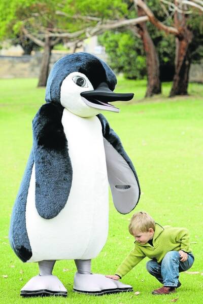 Tommy Ryan, 2, from Timboon, makes friends with the penguin mascot . 110304LP27 Picture: LEANNE PICKETT to help promote the Middle Island Project.2 yr old Tommy Ryan from Timboon