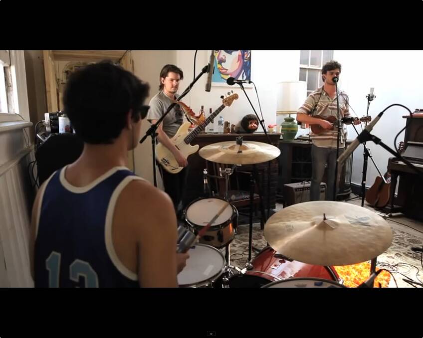 Jono Colliver (centre) and James Keogh (right) performing together for a live Vance Joy clip on YouTube.