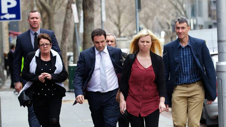 Former AFL star Paul Salmon, left, heads into court in support of his friend Anthony Vippond (centre) earlier this month. Photo: Simon O'Dwyer