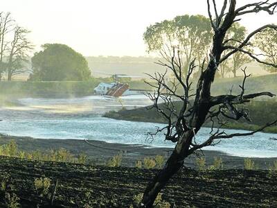 A water-bombing helicopter refills at a dam while battling a fire near Carapook on Wednesday. PICTURE: Charlotte Davis