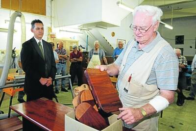 Triton Woodworkers president Jim Abraham presents Warrnambool Mayor Michael Neoh with a cheeseboard made from redgum timber salvaged from the old Hopkins River bridge. 100303RG15 Picture: ROB GUNSTONE