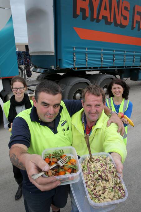 Community health co-ordinator Carly Dennis (left), drivers Paul Brown and Andrew McLean, and dietitian Berni Thomas enjoy some of the healthier lunch options for Ryans Transport drivers. Picture: ROB GUNSTONE 