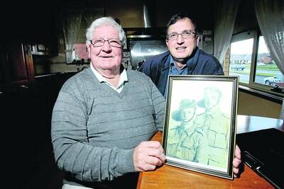 Ray Dalton (left), and military historian Peter Bakker, with a picture of Ray's father and brother who were killed when the Japanese prisoner of war ship, the Montevideo Maru was sunk on July 1 1942.