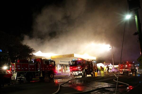 Fire crews battle the toxic blaze at Murray Goulburn's farm supplies and hardware store in Koroit.