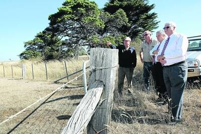 Landowners John Anscombe, left, and Paul Lewis point out the site of the wind farm beside the Woolsthorpe-Heywood Road to Moyne Shire councillors Colin Ryan and Ken Gale.