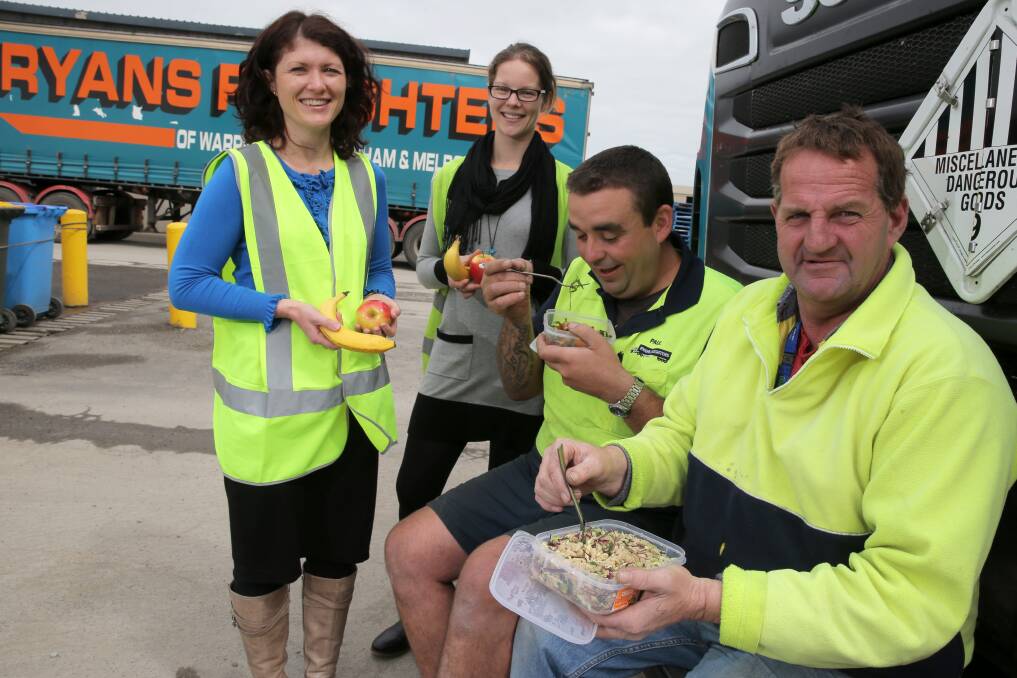 Dietitian Berni Thomas and project manager Carly Dennis share some healthy lunch tips with Ryans drivers Paul "Special" Brown and Andrew "Butch" McLean. Picture: ROB GUNSTONE