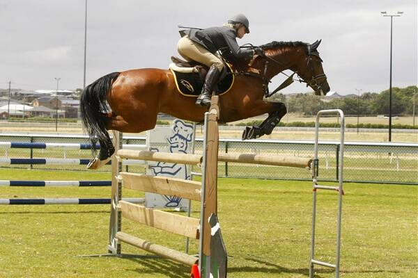 Jess Barton, pictured aboard Lamaz last month, took out the C and D grade championships at the Victorian Indoor Showjumping Championships.