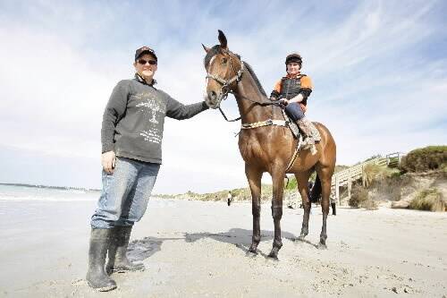 Owner Anne McGrath leads Tears I Cry and jockey Kerry Newby along the Port Fairy beach in her new role as trainer. 080926VH04 Picture: VICKY HUGHSON