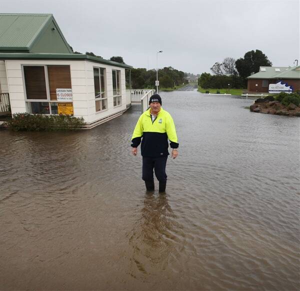 Manager of the Southcombe caravan park Bob Napier surveys the flood water yesterday.    100811AM14 Picture: ANGELA MILNEHeavy rain and  flooding - Pictured standing in flood waters