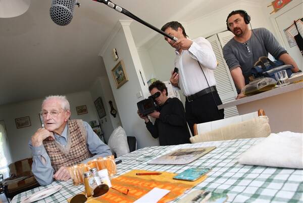 Roland Murphy reflects on turning 100, as documentary producer Nick Heydon (second right), and his camera crew Tim Metherill and Paul Williams capture the moment.
