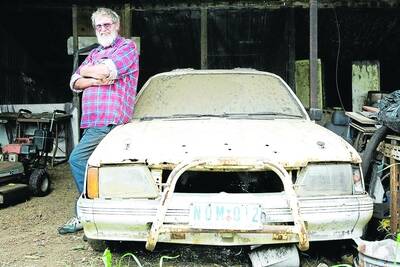 Allan Marsh on his poultry farm with his HDT Group A VK Commodore touring car.