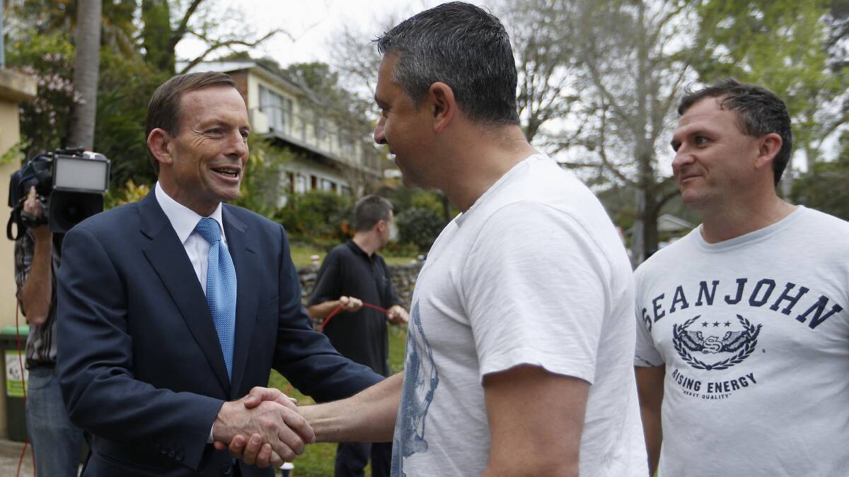 Prime Minister-elect Tony Abbott greets a supporter as he leaves his house in Sydney on September 8. Photo: REUTERS
