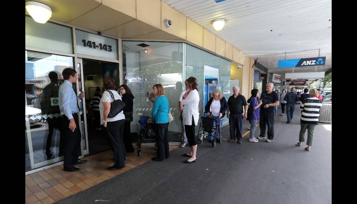 Customers queue outside the ANZ bank yesterday.
